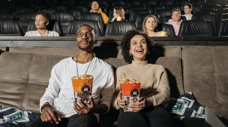 Couple Holding Popcorn Watching a Movie